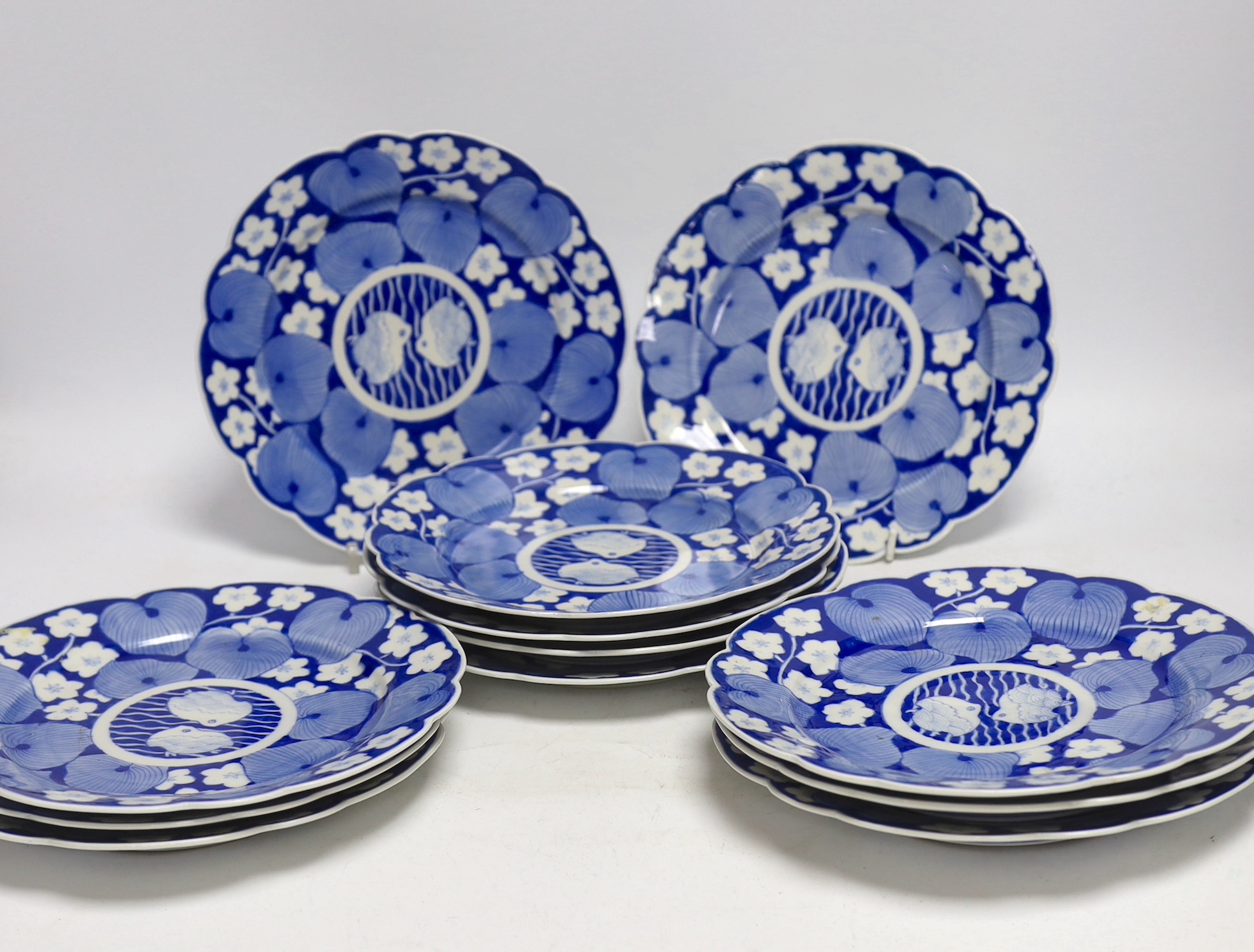 Twelve Japanese blue and white ‘fish’ plates, 21cm diameter